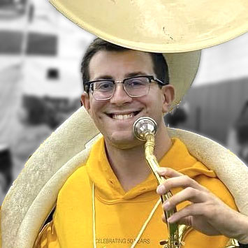 Man holding a sousaphone smiling